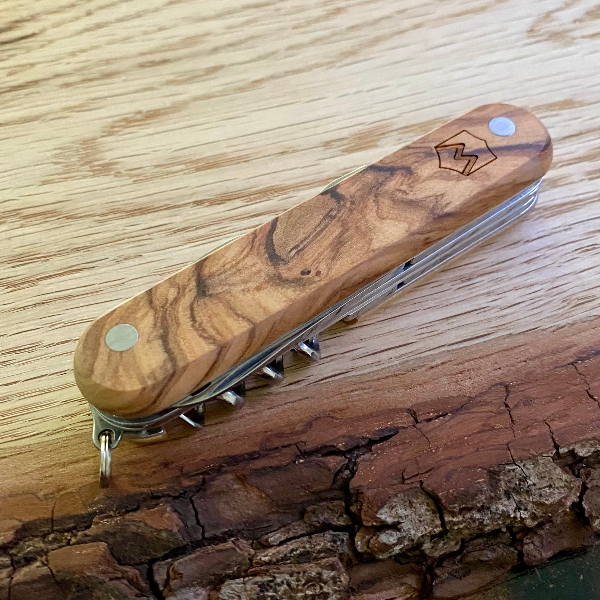 Multifunktionstaschenmesser mit Korkenzieher, Kapselheber, Dosenöffner, Ahle und Säge. Griffschalen aus Olivenholz.